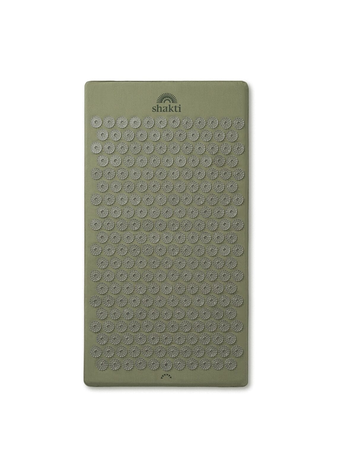 A green Shakti Mat used for acupressure and recovery after a hot yoga practice.