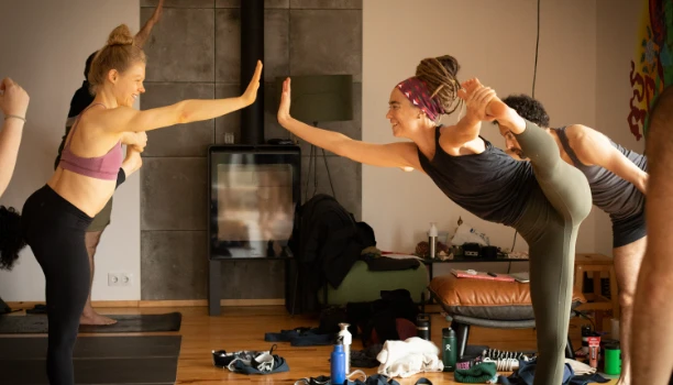 Hot Yoga Travel Co. founders practicing yoga poses at Monte Albán ruins, combining travel with mindful movement.