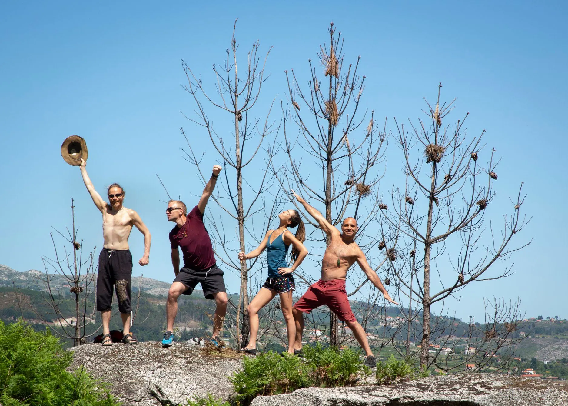 A group of cheerful participants posing outdoors during a yoga retreat peru with the scenic Andes mountains in the background.