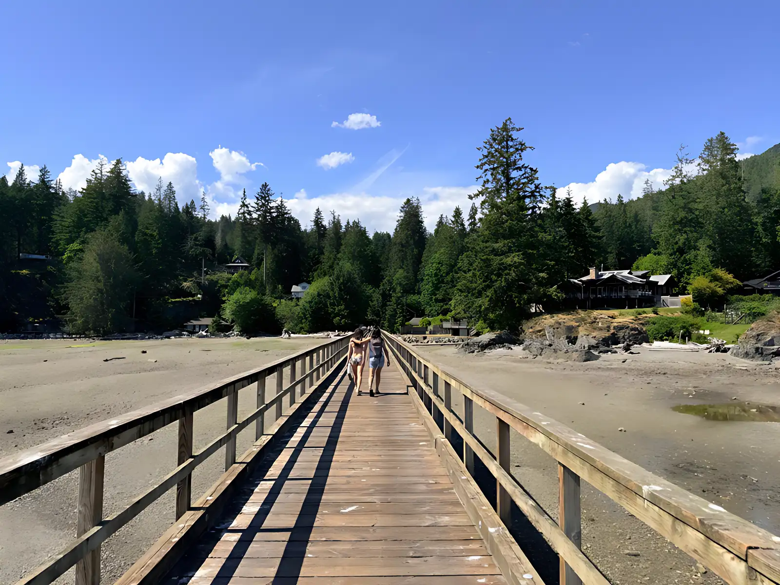 two women on a bridge holding hands at the Hot Yoga Retreat in Canada