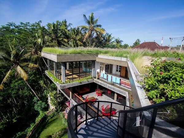 Building with a grass roof and people in a yoga studio